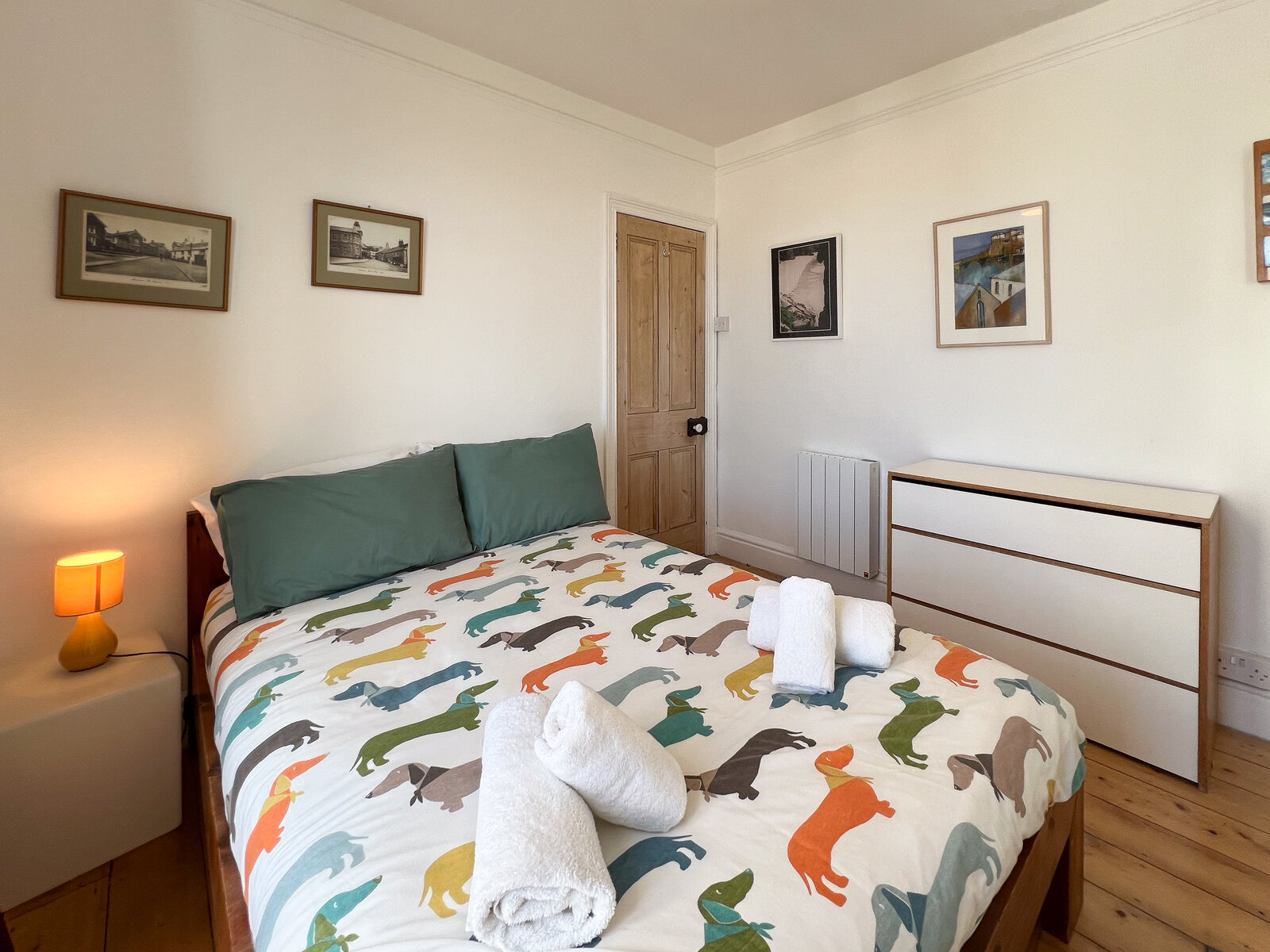 Second double bedroom with chest of drawers and seaside prints