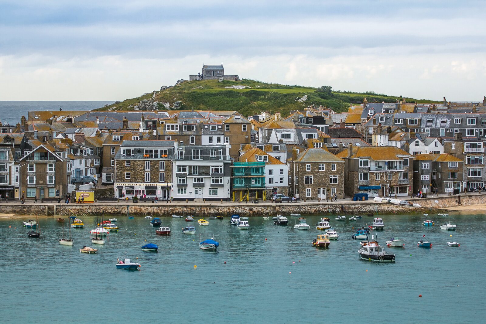 St Ives harbour with fishing boats below the town and chapel