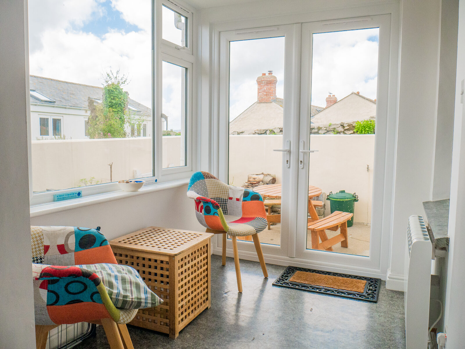 Sun lounge with colourful chairs opening to the patio